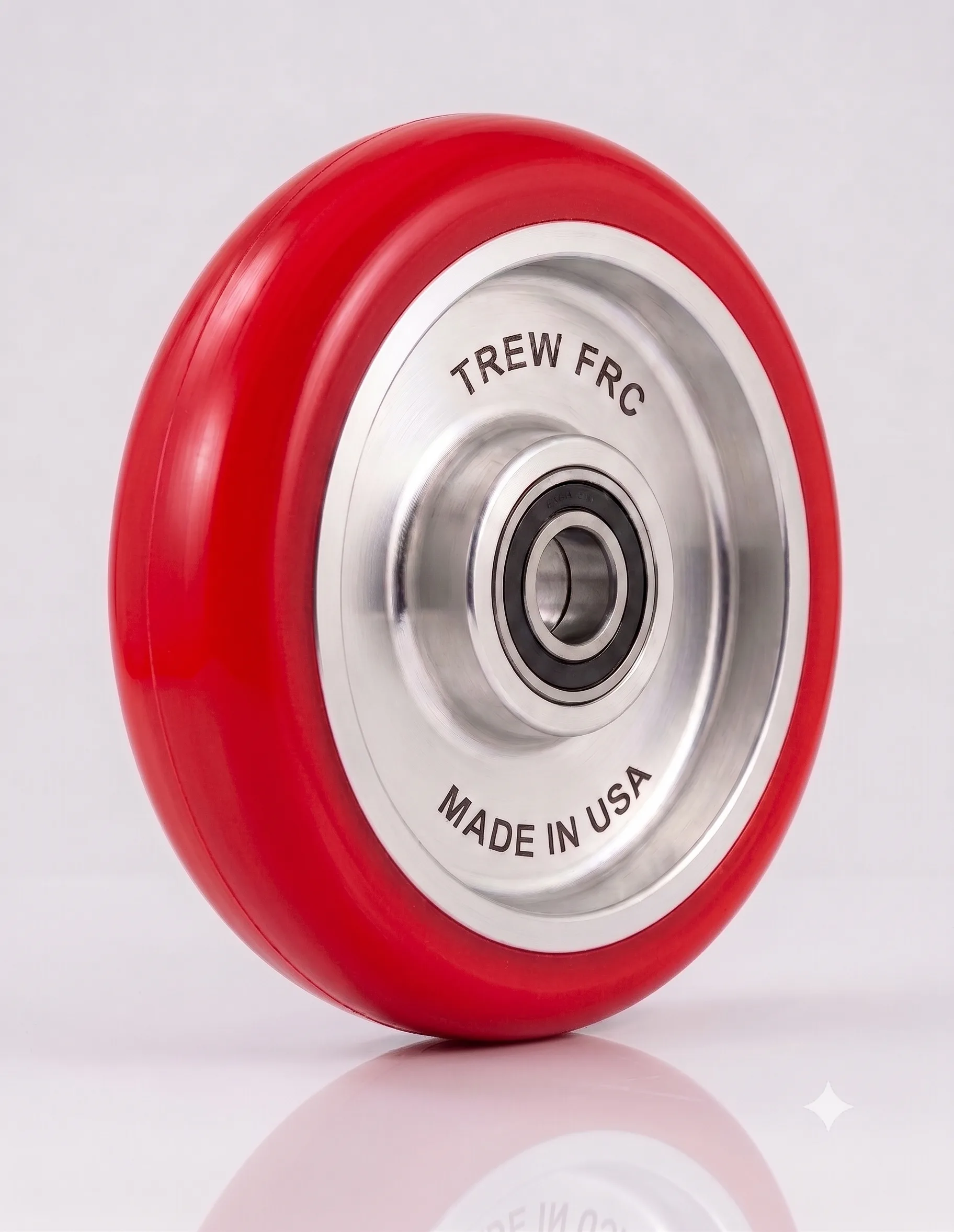 Red polyurethane wheel with silver core, labeled TREW FRC Made in USA, reflecting quality manufacturing.
